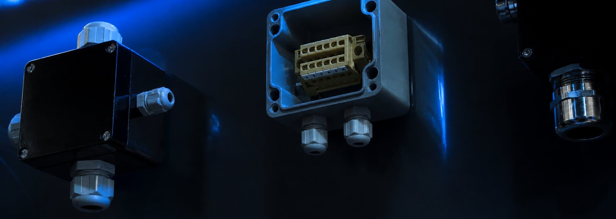 Industrial enclosures installed on a plant wall at night